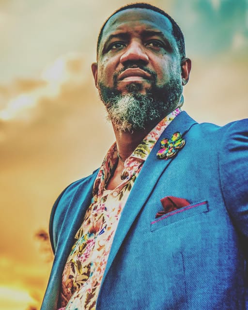 Patrick Francis Sr. in a blue blazer at sunset