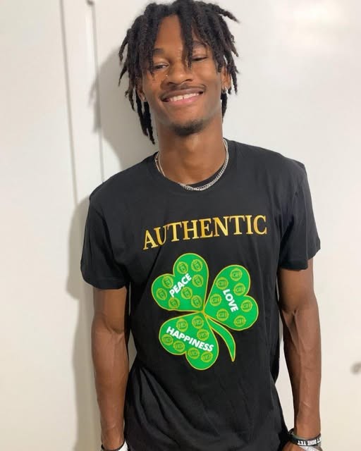 Black Authentic tee with the green clover reading Peace, Love, Happiness